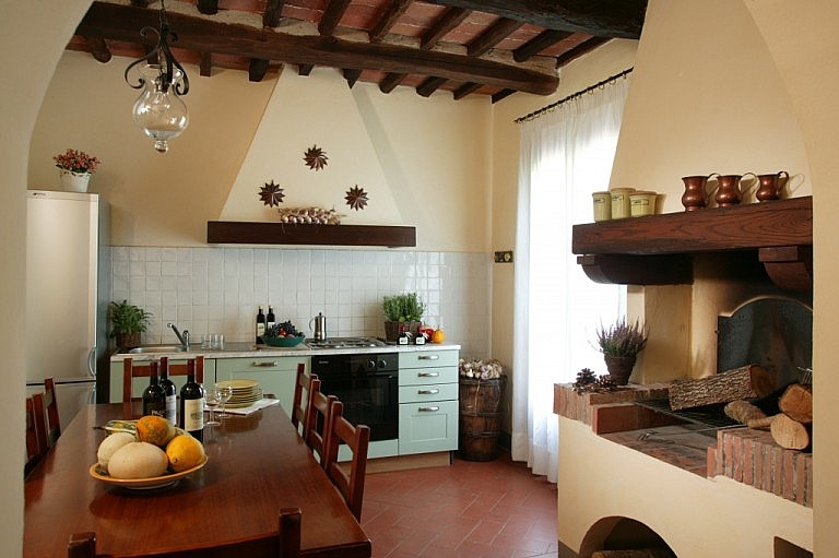 Elegant kitchen with fireplace in Tuscan country cottage for large groups