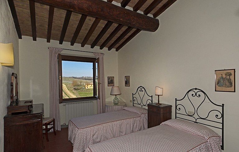 Twin bedroom with view over chianti vineyards