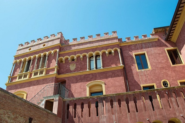 Multi colored facade of an eclectic castle near Pisa