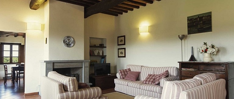 Elegant sitting room with fireplace in Tuscan agriturismo