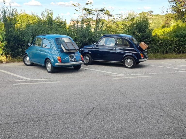 Vintage fiat 500 car arriving in Lari village